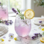 Sparkling lavender lemonade with THC in a glass with lemon slices and lavender sprigs
